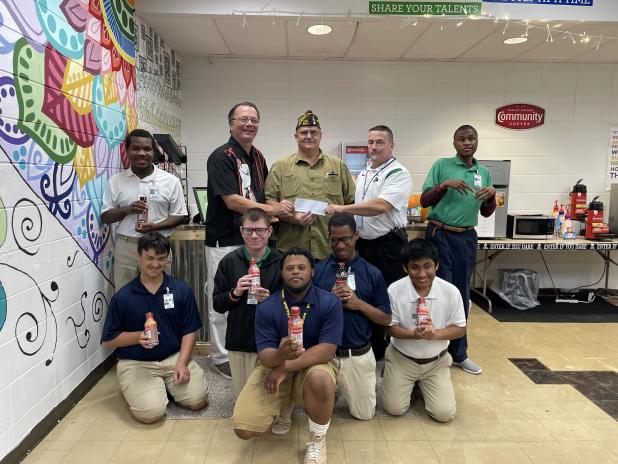 Donnie Fontenot, Commander of VFW Post 8971, in Eunice presented a monetary donation to the Eunice High School Renaissance Cafe Coffee Shop run by the Special Education Department.