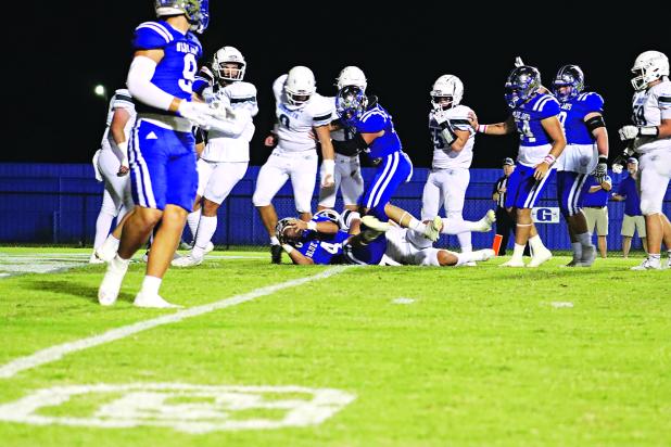 St. Edmund’s Nathan Driggs, No. 4, running back and kicker, makes the first touchdown of the evening during last Friday’s over time win of 52-50 over Catholic-Pointe Coupee. (Photo by Amy Myers)