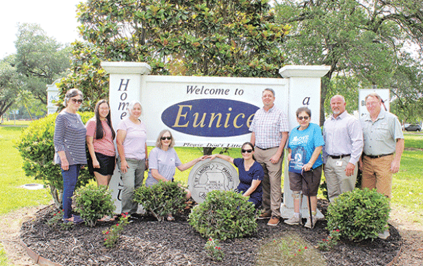 The Welcome to Eunice entrance sign on U.S. 190 east received a refresh by members of the Bulb & Blossom Garden Club. Volunteers re-worked the flowering bed and planted Petite Knock out roses as their project for Arbor Day. Other flowering plants, trees and greenery include two Magnolia trees, ligustrums, and Indian Hawthorns. From left are Lynn Pavich, Sarah Bollich, Fran Guillory, Martha Guempel, Christie Spekschate, Mayor Scott Fontenot, Donna Baltakis, David Ingram and Randy Miller. Participants not pic