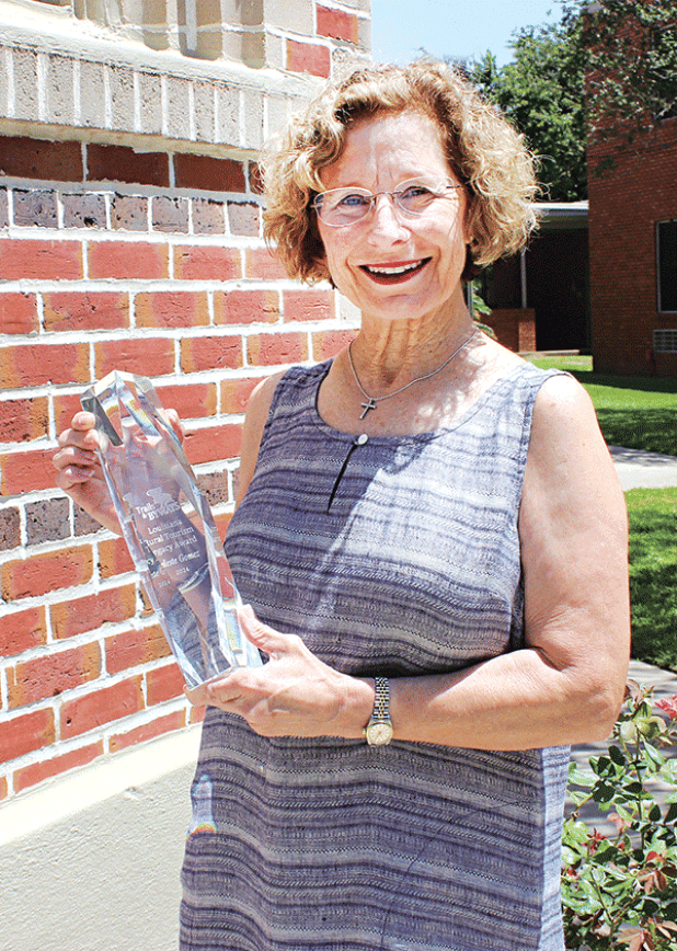 Celeste Gomez, of Eunice, holds the first Lt. Governor’s Rural Tourism Legacy Award presented to her on June 12. (Photo by Myra Miller)