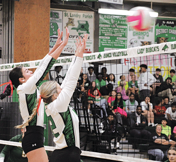 Eunice High volleyballers Madelyn Smith an Brooklyn Darbonne stretch to block a ball. 