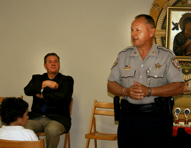St. Landry Parish Sheriff's DARE officer Theme Ledee, right, is shown during a program at St. Edmund Elementary School in 2009. At left, seated, is Sheriff Bobby Guidroz. (File photo)