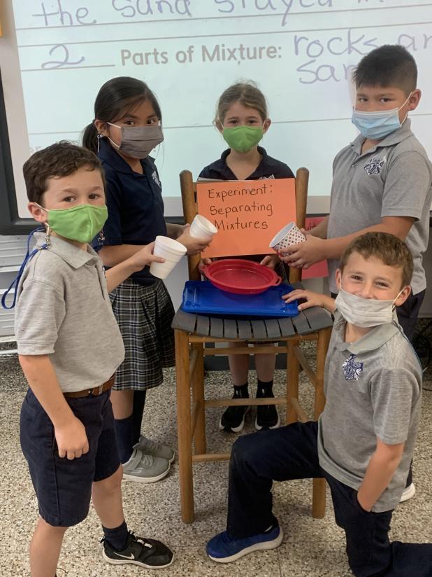 Second graders in science class at St. Edmund learn to separate mixtures.
