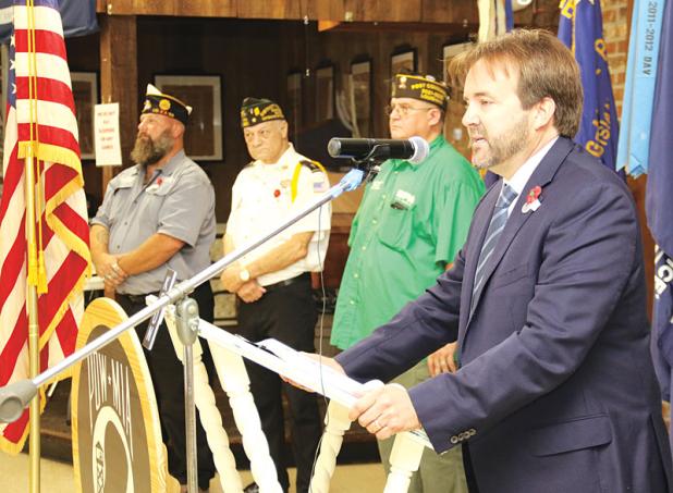 State Rep. Phillip DeVillier, right, speaks at the Eunice VFW Veterans Day celebration on Thursday. Also shown, from left, are David Crader, American Legion Post commander, Donald Estilette, VFW Post chaplain; and Donnie Fontenot, VFW Post commander. More photos on Page 16. (Photo by Harlan Kirgan)