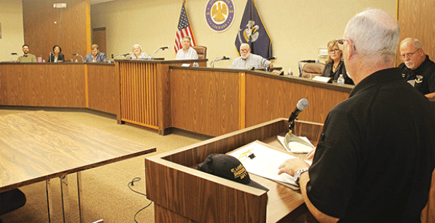 St. Landry Parish Sheriff Maj. Mark LeBlanc, right, speaks at the Eunice city council meeting on Tuesday about a planned Crime Stopper program to combat littering and dumping in the parish. Shown, seated from left,, are Alderman Chad Andrepont, Alderwoman Germaine Simpson, City Attorney Stan Feucht, City Clerk Ginny Moody, Mayor Scott Fontenot, Alderman at-large Marion “Nootsie” Sattler, Alderoman Connie Thibodeaux and Police Chief Kyle LeBouef. (Photo by Harlan Kirgan)