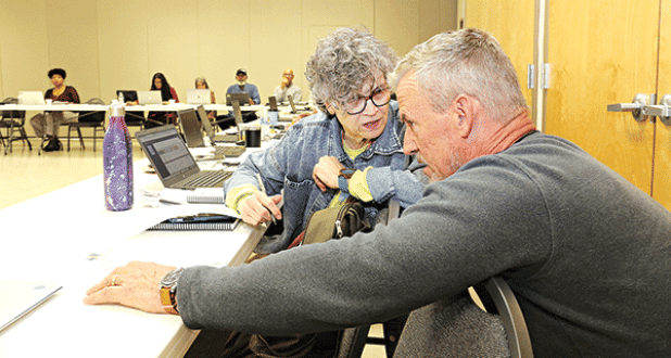 St. Landry Parish School Board member Mary Ellen Donatto confers with Lyn Kenley of Volker during Monday’s retreat. (Photo by Harlan Kirgan)