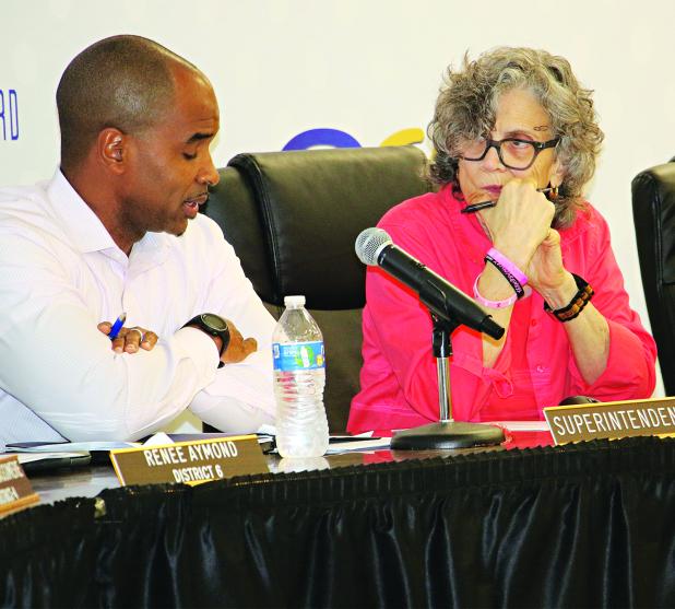St. Landry Parish School Superintendent Milton Batiste III and School Board President Mary Ellen Donatto confer during Tuesday’s Committee of the Whole meeting. (Photo by Harlan Kirgan)
