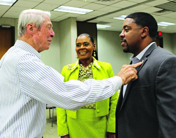 Don Mayeux, left, Angelia Guillory and State Representative Dustin Miller converse before the meeting at the Eunice Rotary Club meeting Wednesday. Mayeux is admiring Miller’s House of Representative pin. Miller was Guillory’s guest at the meeting. (Photo by Myra Miller) 