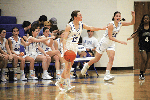 St. Edmund’s Caroline Lavergne sets up a play in the game with Eunice High on Tuesday. In the background is Lady Jay Aubrie LeJeune and Lady Cat Simone Lewis. (Photo by Rhett Manuel)