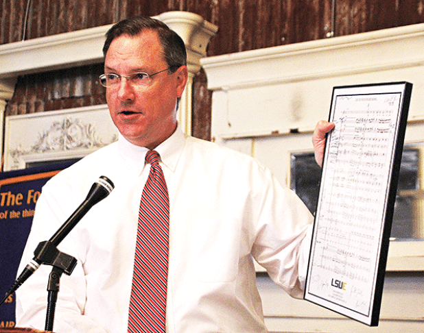 Dwight Jodon holds up the sheet music for the LSU Eunice Fight Song at the Eunice Rotary Club meeting on Nov. 23. (Photo by Tom Dodge)