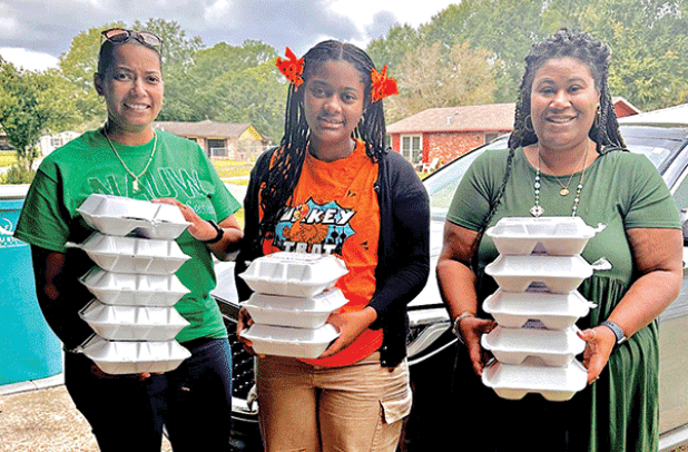 Thanksgiving dinners were delivered to special people by NAUW Eunice Branch. Dinners were prepared for the organization by Rosaline Allison Williams and delivered by LaJuana J. Ray, left, NAUW member; Jordan K. Ray, and Shelsy Williams, branch president of NAUW. Not pictured is Keveius Givs Jr. Givs delivered dinners. (Submitted photo)