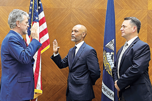 From left, St. Landry Parish Clerk of Court Charles Jagneaux administers an oath of office to Ogden Pitre as District Attorney Chad Pitre looks on. (Submitted photo)