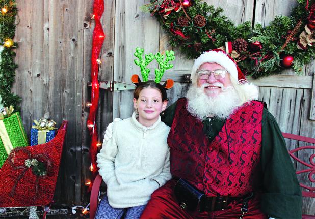 Adalyn Doucet made her Christmas wishes known to Santa at the 2023 Eunice Community Garden Christmas Festival. The festival returns from 5 to 7 p.m. today. (Photo by Myra Miller) 