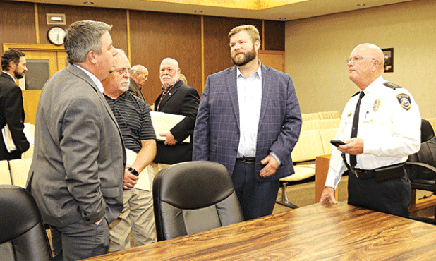 Eunice city officials gather after Tuesday Board of Aldermen meeting. From left, are Chad Andrepont, alderman; Scott Fontenot, mayor; Kyle LeBouef, incoming police chief; Ernest Blanchard, alderman; Marion “Nootsie” Sattler, alderman at-large; Stan Feucht, city attorney; and Randy Fontenot, police chief. (Photo by Harlan Kirgan)