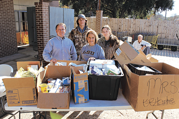 Donnie Richard, a Rotarian, delivered 456 pounds of food items from Highland Early Learning Center Tuesday at the Eunice Food Bank Food Drive. From left, are Richard, Owen Young, Pam Joubert, and Bailey Young.  (Photo by Myra Miller)