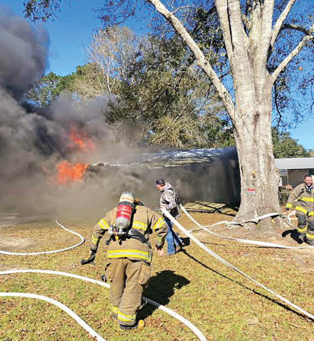 Acadia Parish Fire District 4 firefighters race to a house fire at 227 McManus Road on Sunday. The house of La. 13 south of Eunice was destroyed. Turn to Page 2 for the story and an additional photo. (Photo courtesy of Fire Chief Harral Johnson)