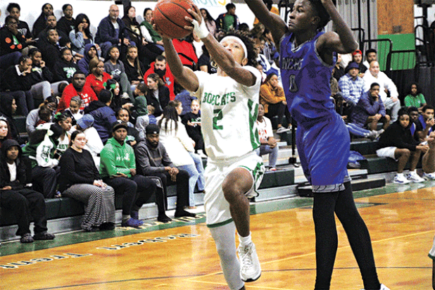 Lady Cats guard Akeviona Monday dribbles past a North Central defender in last Friday’s loss to the Lady Hurricanes.(Photo by Rhett Manuel)