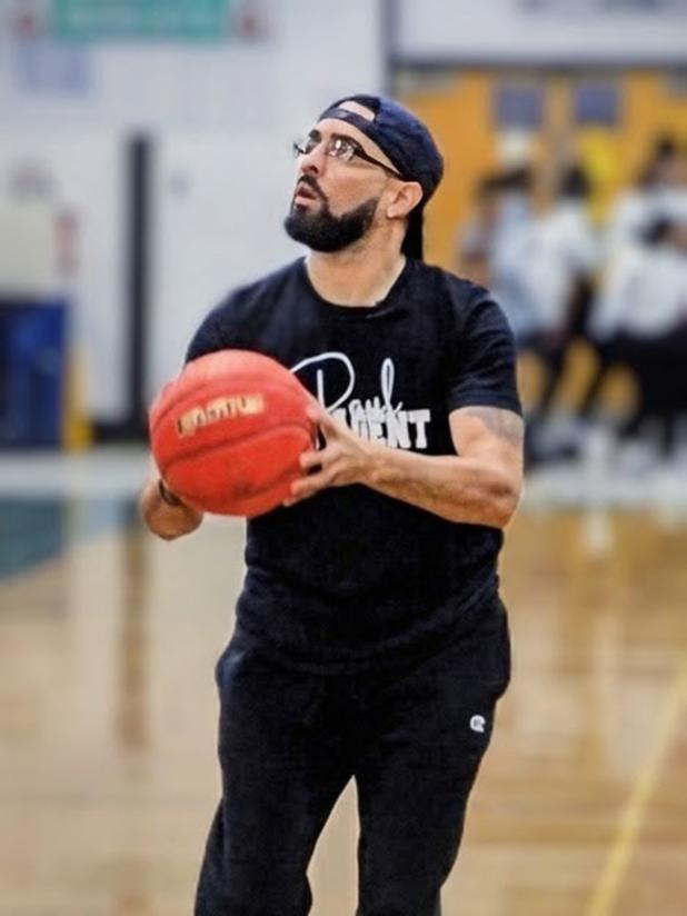 Paul DeRousselle shoots a three-pointer during the “Shoot Your Shot” fundraiser held Friday night at halftime of the Mamou-Eunice boys basketball game. DeRousselle sank 9-of-25 three pointers on his way to raising nearly $6,000 for Eunice’s basketball programs as of press time. (Photo by Sports Editor Rhett Manuel)
