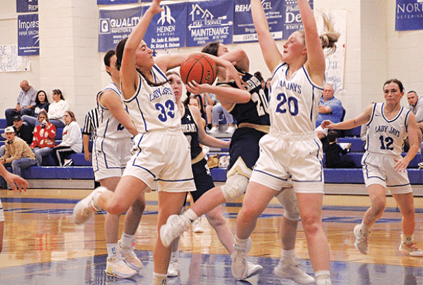 St. Ed’s Jillian Devillier and Ava Smith defend Sacred Heart’s Alyssa Brignac during a game of the Brad and Kendall Fontenot Memorial Shootout held at St. Ed’s last week. (Photos by Rhett Manual)