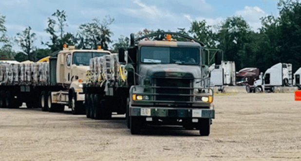 The Louisiana National Guard lines up trucks and trailers ready to deliver food and water to affected citizens following Hurricane Ida at the Regional Staging Area in Tangipahoa Parish, Louisiana, Aug. 28. 2021. In addition to 195 high-water vehicles and 73 rescue boats prepped and staged across south Louisiana, the LANG has 34 helicopters ready to support search and rescue, evacuation and recon missions as needed. (U.S. Army National Guard courtesy photo)