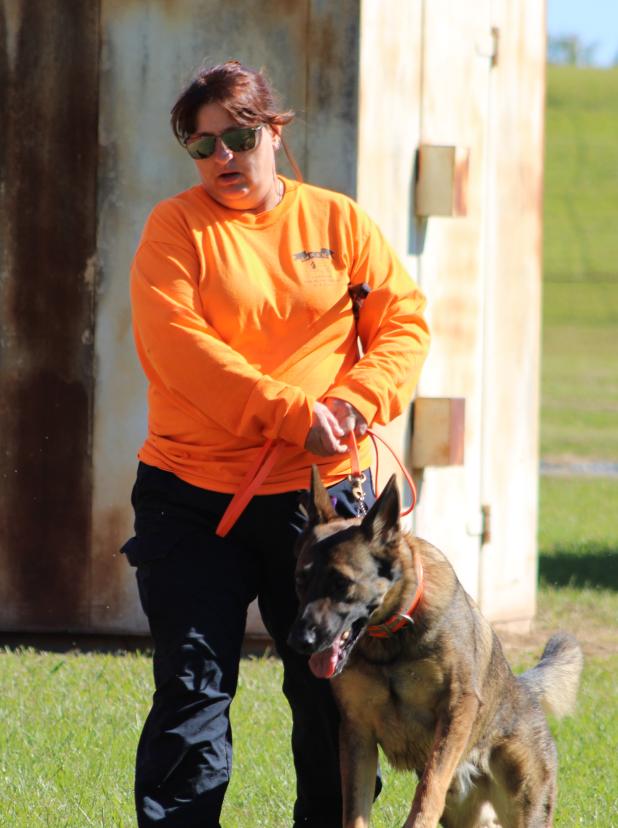 Kirsten Watson and her German Shepherd Quest getting ready to practice detecting remains. (Photo by Calista Rodal/LSU Manship School News Service)