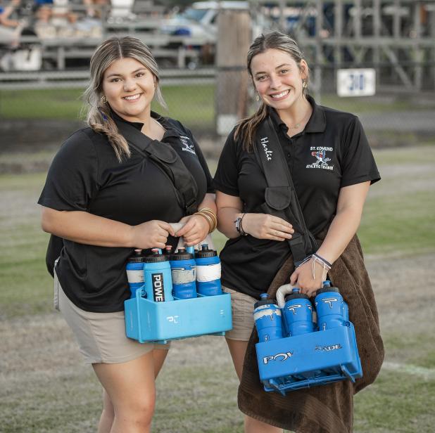 St. Edmund athletic trainers Ashlyn Marcantel and Harlie Guillory stop for a photo during the game against WCA Lafayette. (Photo by Dwight Jodon)