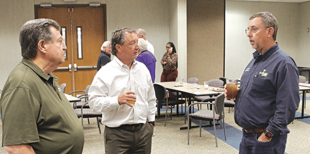 St. Landry Parish President Jessie Bellard, right, discusses the proposal to build a juvenile detention facility to serve nine parishes with retired, from left, retired District Judge Ellis Daigle and Eunice attorney Donnie Richard after Wednesday’s Eunice Rotary Club meeting. (Photo by Harlan Kirgan)