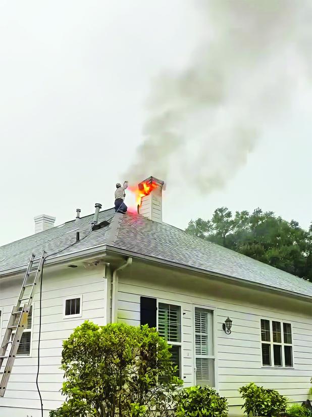 SLEMCO lineman Matt Reed used a hose to douse a house fire near Church Point on July 17. (Submitted photos)