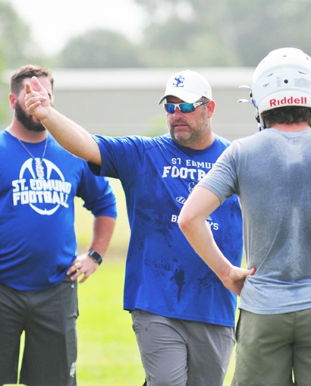 St. Ed's Nick Trosclair talks with a Blue Jay player