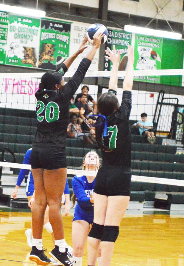 Eunice High’s Gabby Mitchell blocks a shot from St. Edmund as Maci Vincent assists on the play. (Photo by Tom Dodge)