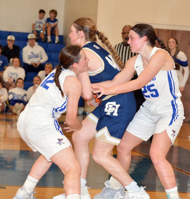 St Edmund’’s Caroline Lavergne and Millie Miller battle Sacred Heart’s Rose Ardoin for a jump ball.