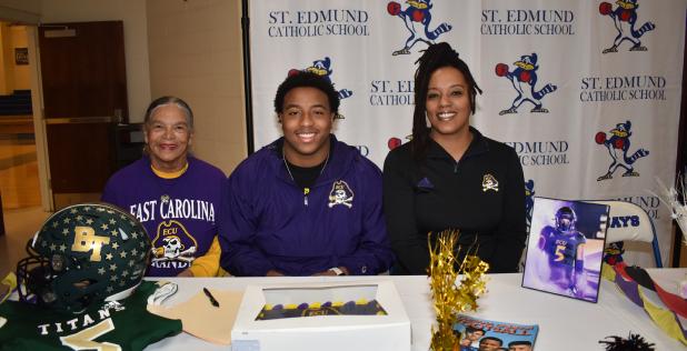 Kieran Davis returned to St. Edmund where he signed to play football for East Carolina. From left, are, grandmother Velma Davis, Kieran, and his mother, Lena Davis. (Photo by Tom Dodge)