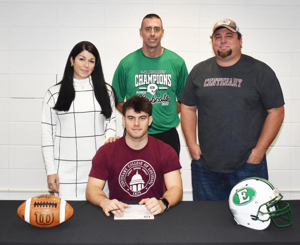 Eunice High’s Josh Brown, sitting, signed a national letter of intent to play football at Centenary College in Shreveport. Standing, from left, are his mother Kelly Arceneaux, Eunice head football coach Andre Vige and father Lance DeRouen.