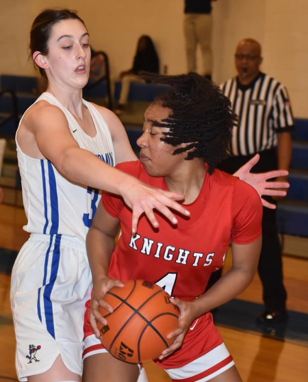 St. Edmund’s Madison Comeau defends Slaughter Community Charter’s Aubrie Jefferson. 