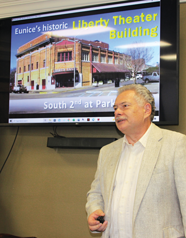 Paul Feavel shows a photo of how the Liberty Building appeared before renovation. (Photo by Myra Miller)