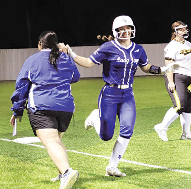 Beth Miller getting a high five from Coach Nicole Lanthier as she rounds third base after hitting a home run.  (Photo by Amy Myers)