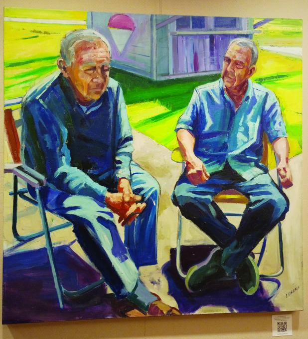 Guys sitting painting 