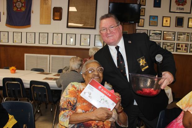 Dorita Augustine of Lafayette wins a door prize, with her is Chief Deputy Eddie Thibodeaux of St. Landry Parish Sheriff’s Office. (Photos by Myra Miller)