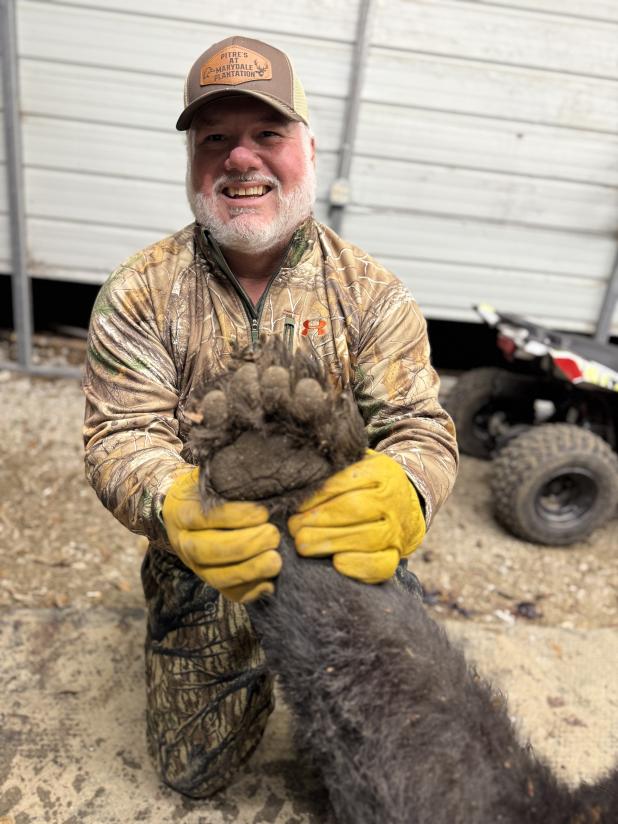 Perry Pitre Jr. with a black bear paw. (Submitted photo)