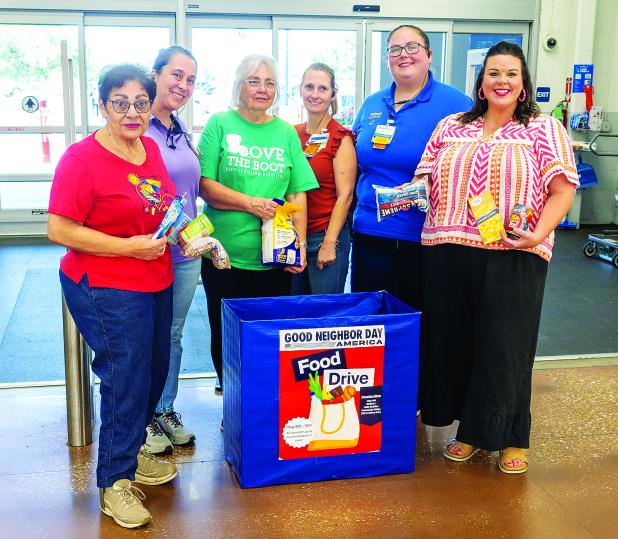 Posing in front of the Food Drive collection box at Walmart are, at left, Donna Baltakis, director of Keep Eunice Beautiful, sponsor of the drive; at third from left, KEB board member Fran Guillory; and, at right, Katie Richard, founder of Belly Buddies. They are pictured with Walmart associates Amanda Aymond, Rebecca Bordelon, and Courtney West. (Photo by David Simpson)