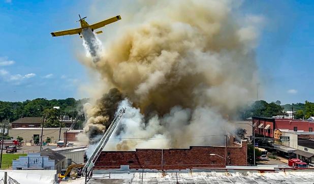 This spectacular photo by Dwight Jodon shows a crop-duster plane dumping water on the Nick's on 2nd fire  on Saturday. The photo reveals the extent of damage to the landmark restaurant. 