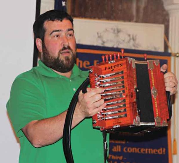 Rusty Sanner, of Milton, shows one of his accordions at the Eunice Rotary Club meeting on Wednesday. (Photo by Myra Miller)