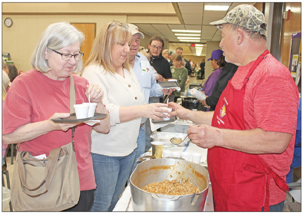 The Taster’s Choice event was held Wednesday evening. Above, are Pat Bordelon, and Michelle Soileau receiving a sampling of crawfish etouffee from Malcolm Darbonne representing the St. Thomas More K.C.’s. 