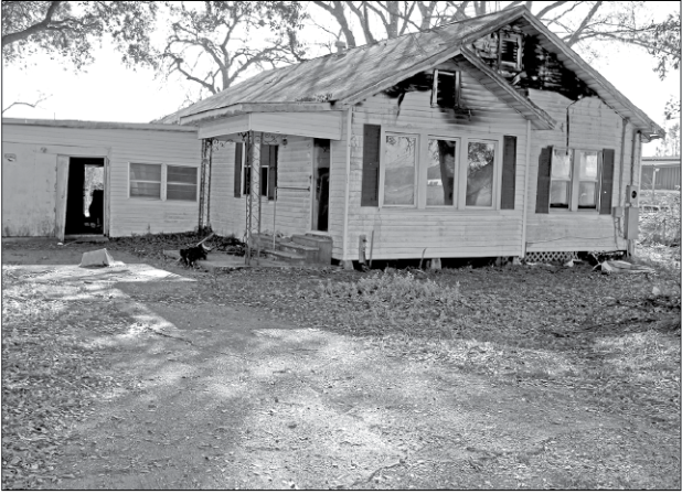 Eunice fire fighters were called to a structure fire at 152 East Ardoin at 4:14 p.m. Friday. According to Eunice Fire Chief Chaise Brown, “The home was unoccupied. It is located next door to Guillory Oil storage tanks.” The cause of the fire is under investigation. (Photo by Myra Miller)