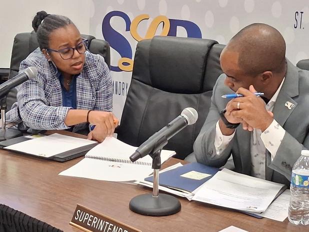St. Landry Parish school board member Bianca Vedell poses budget questions to superintendent Milton Batiste III following the thursday night meeting