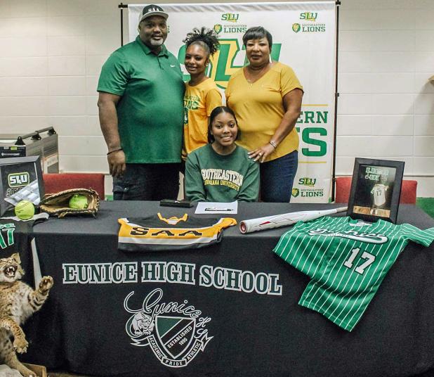 Eunice High senior Gabby Mitchell, sitting, signed this week to play softball at Southeastern Louisiana University. Standing, from left, are her father, Ernest Mitchell III, sister, Madison Mitchell and mother, Patina Mitchell.