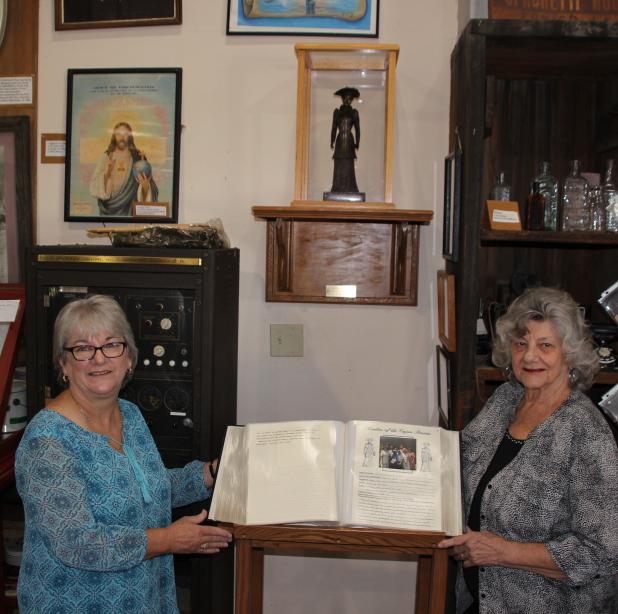 Judy Young, a hostess at the Eunice Depot Museum, and Lou Myers of the Beta Sigma Phi are at the viewing of the bound bound “Ladies of the Cajun Prairie” at the Eunice Depot Museum. (Photos by Myra Miller)