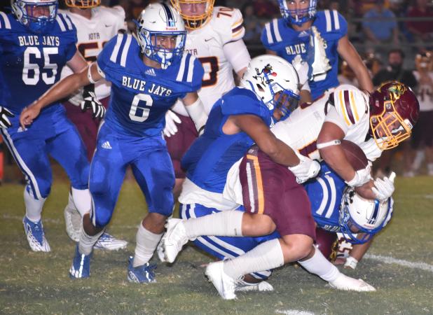 St. Edmund's Marcus Gradney tackles Iota running back Connor Fruge.