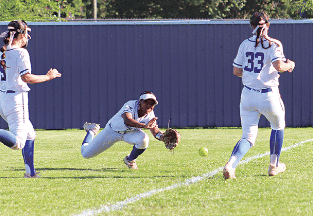 Malori Bellard, a St. Edmund right fielder, dives for a fly ball in the game with Northside Christian. (Photo by Amy Myers)