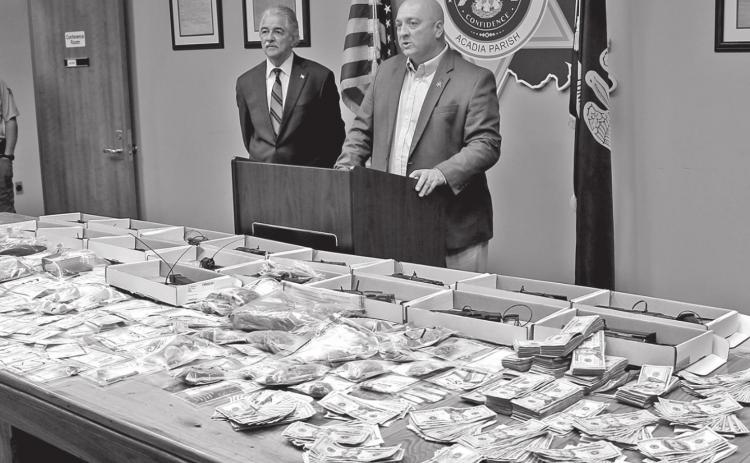 Acadia Parish Sheriff K.P. Gibson, right, addresses media Thursday morning concerning a recently completed 45-day operation that resulted in the confiscation of numerous illegal handguns, a variety of narcotics and currency. Looking on is District Attorney Don Landry. (Photo by Steve Bandy/Crowley Post-Signal)